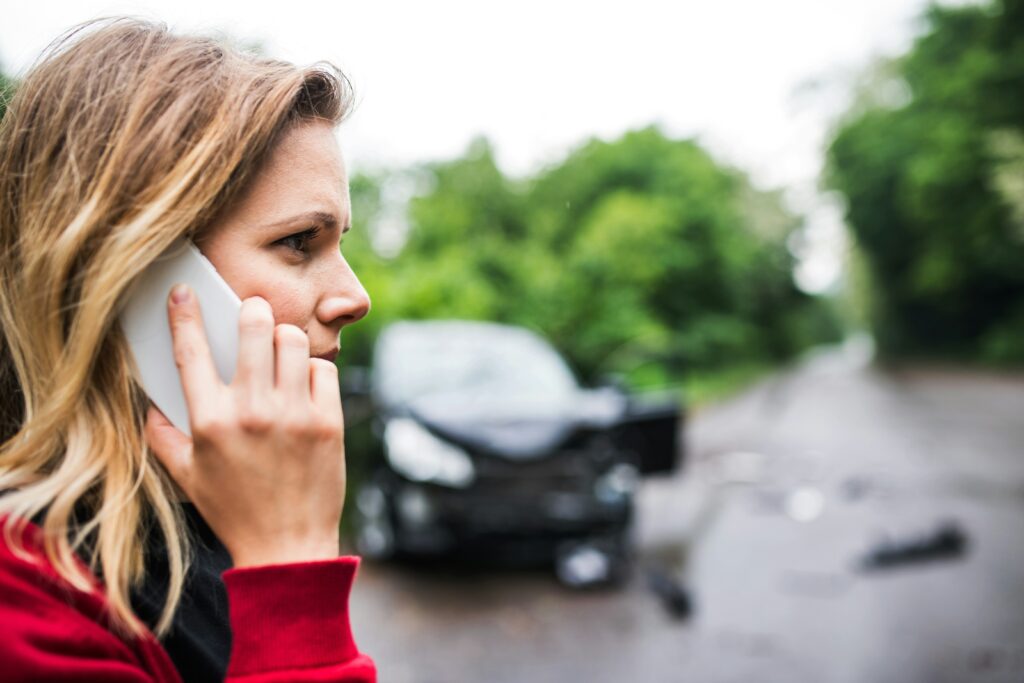 woman calling 911 after a car accident