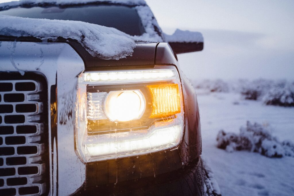 car driving on icy roads during a severe snowstorm