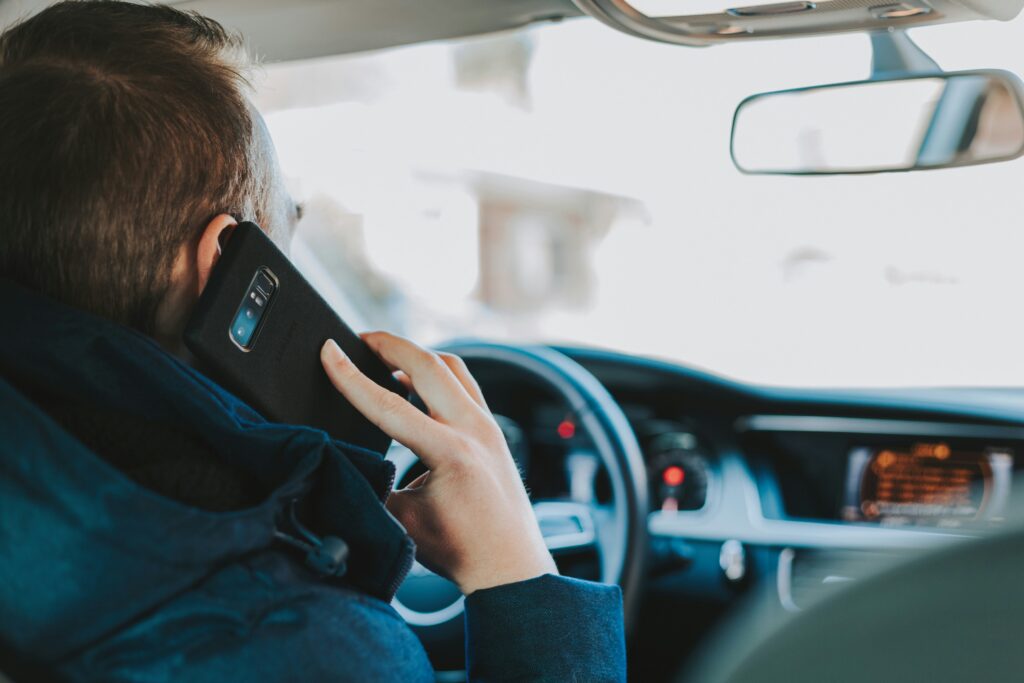 man distracted by a phone call while driving